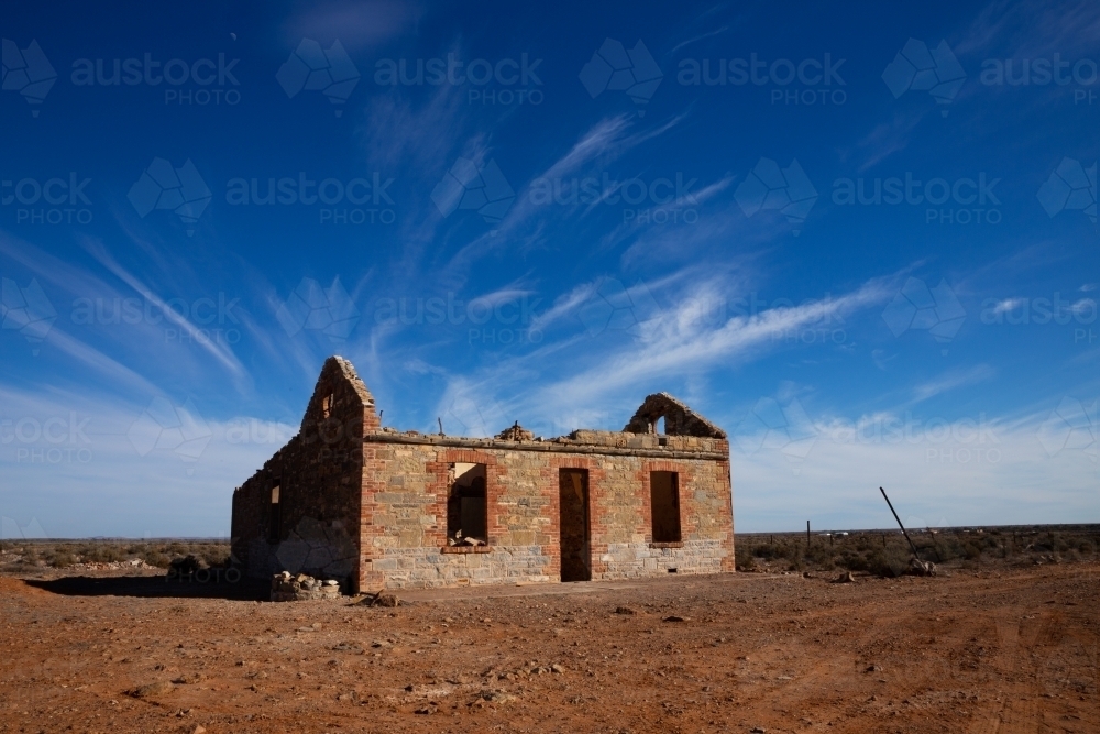 ruin under blue sky with wispy clouds - Australian Stock Image