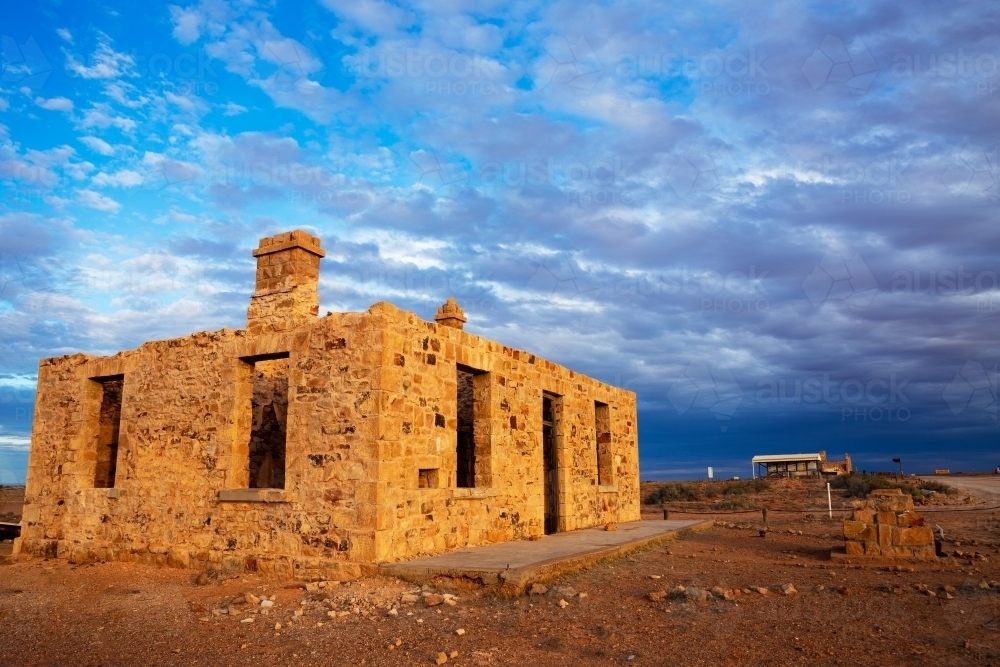 ruin under stormy sky in afternoon light - Australian Stock Image