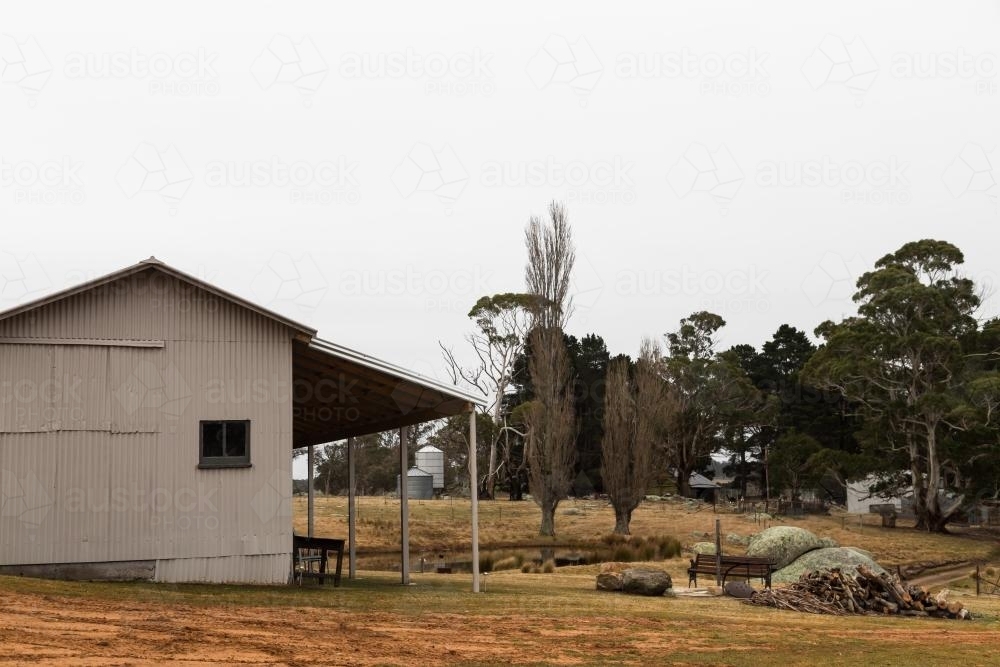 Rural farm buildings with rocks and trees - Australian Stock Image