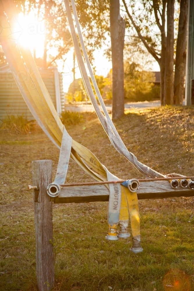Rural fire service fire fighting hose draped on drying frame - Australian Stock Image