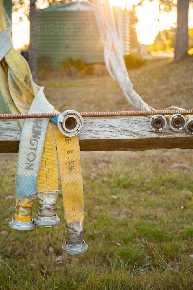 Image of Rural fire service fire fighting hose draped on drying frame ...