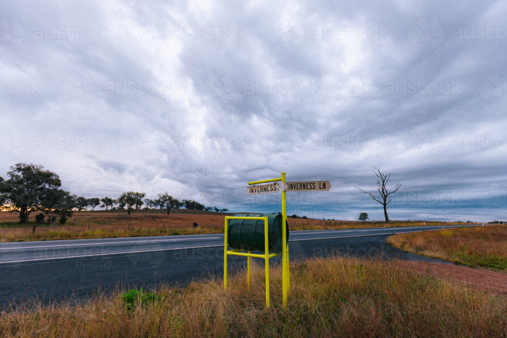 Rural green mailbox with road signs in rural New South Wales - Australian Stock Image