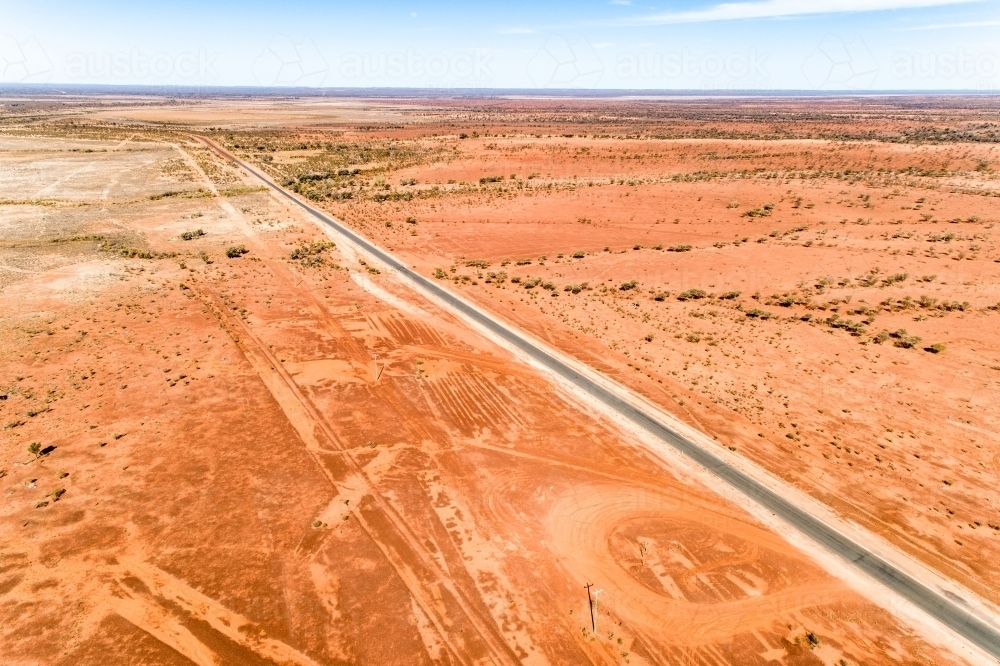 Rural highway cuts through western Queensland in drought. - Australian Stock Image