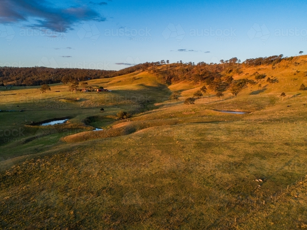 Image of Rural landscape in last light of the day with homestead on ...