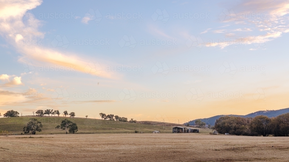 Rural landscape with grassy hills in the evening - Australian Stock Image