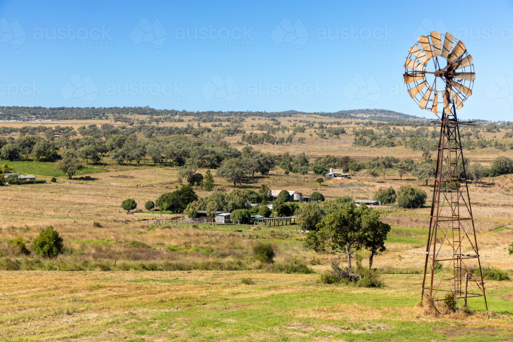 Rural landscape with rusted windmill - Australian Stock Image