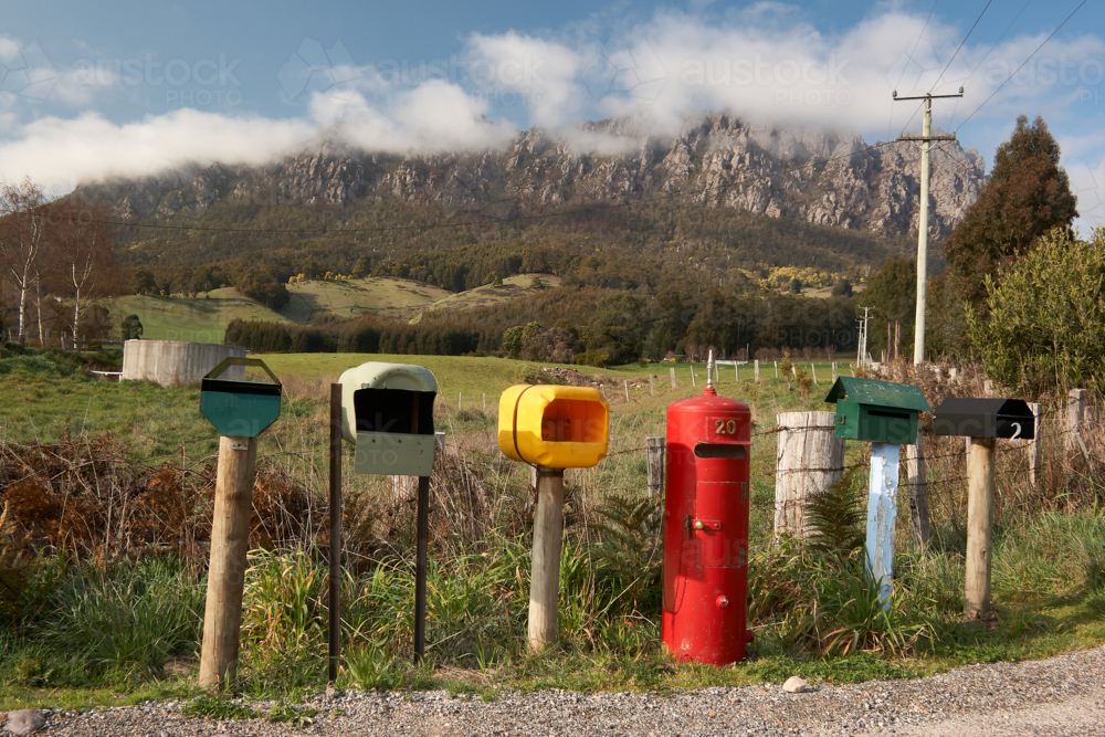 Rural letterboxes in front of cloudy mountain. - Australian Stock Image
