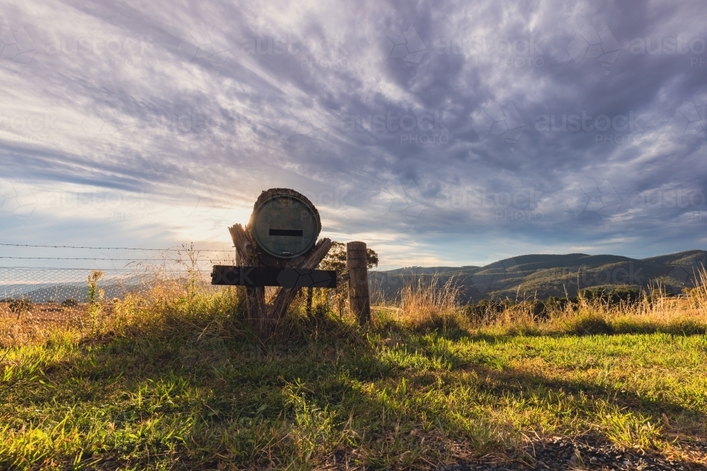 Rural mailbox on ridgeline in regional New South Wales with sun setting in background - Australian Stock Image