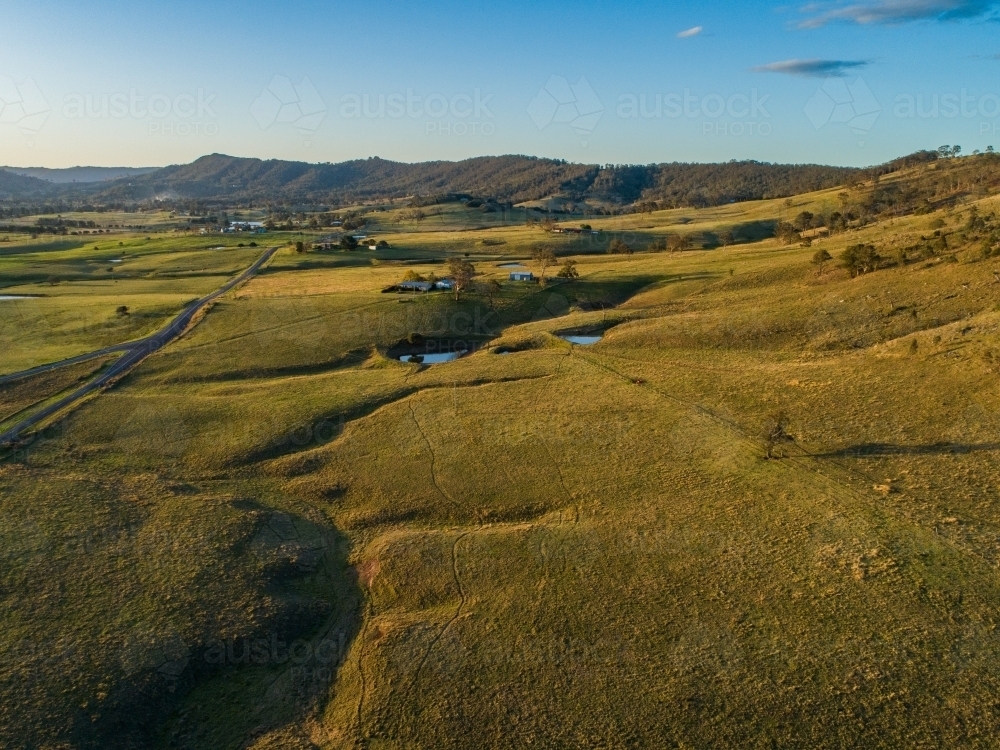 Rural road through green paddocks of Melville in Maitland area of Hunter Valley - Australian Stock Image