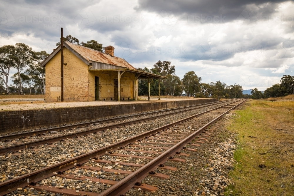 Image of Rural train platform with old railway house - Austockphoto