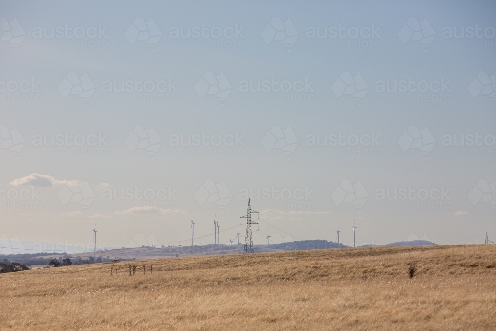 Rural Wind Turbines in a farm setting with Energy wires - Australian Stock Image