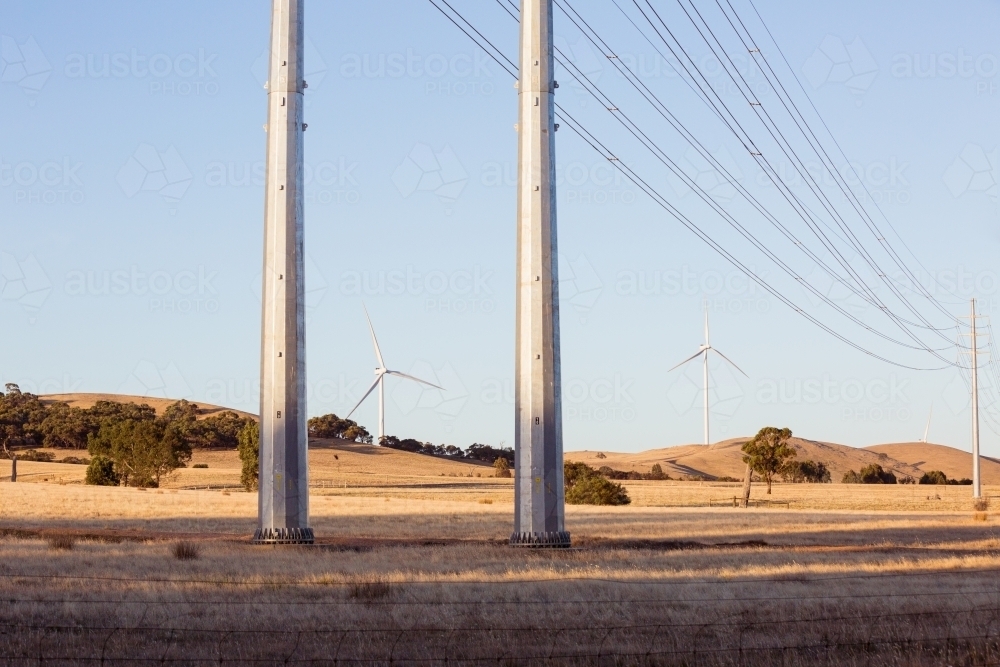 Rural Wind Turbines in a farm setting with powerlines in the foreground - Australian Stock Image