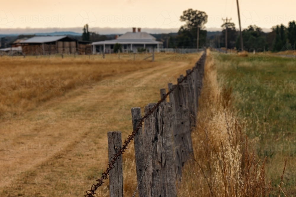 Rustic barbed wire fence on farm in country Victoria - Australian Stock Image