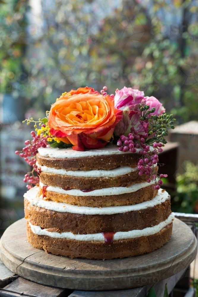 Rustic birthday cake with flowers - Australian Stock Image