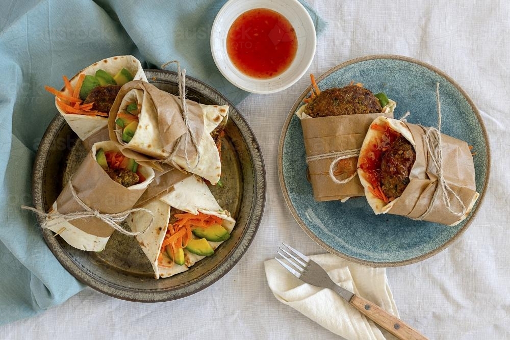 Rustic healthy wraps on plates - Australian Stock Image