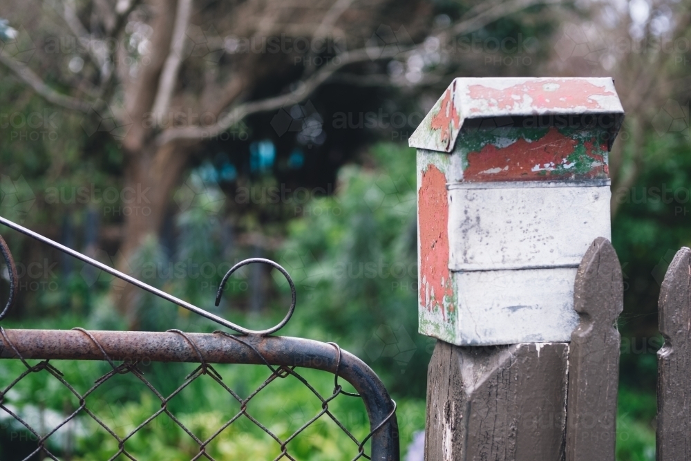 Image of Rustic letterbox on gate of country cottage Austockphoto