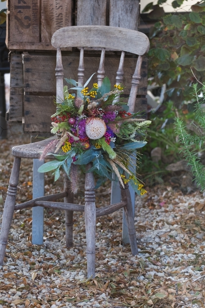 Rustic setting with wildflowers on chair - Australian Stock Image