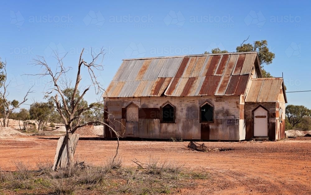 Rusty Church on barren red soil - Australian Stock Image