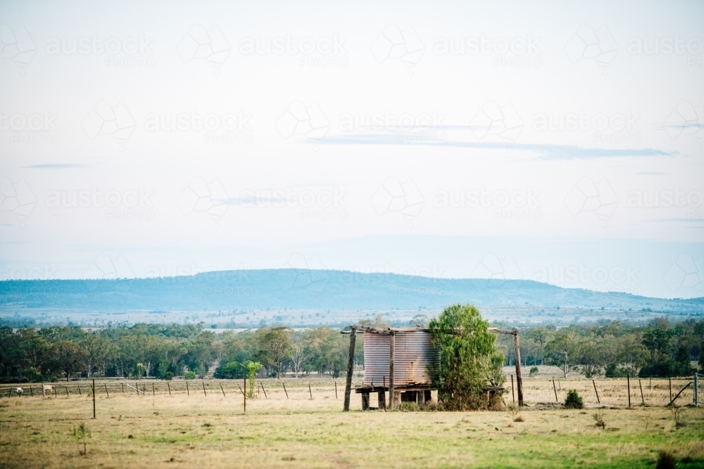 Rusty tank amongst a scenic rural landscape - Australian Stock Image