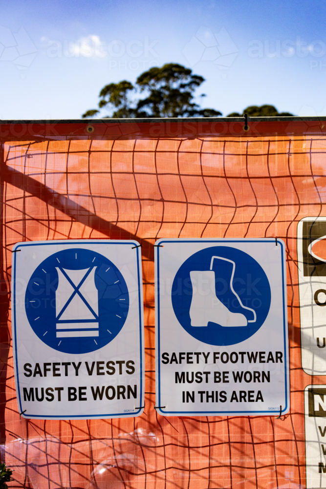 Safety signage on a barrier fence at a construction site - Australian Stock Image