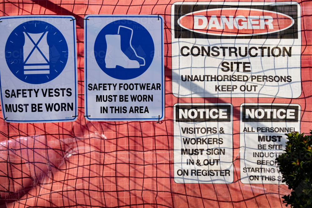 Safety signage on a barrier fence at a construction site - Australian Stock Image