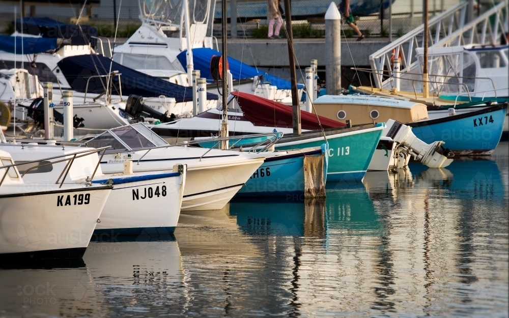 Sail boats and motor boats moored at a harbour - Australian Stock Image