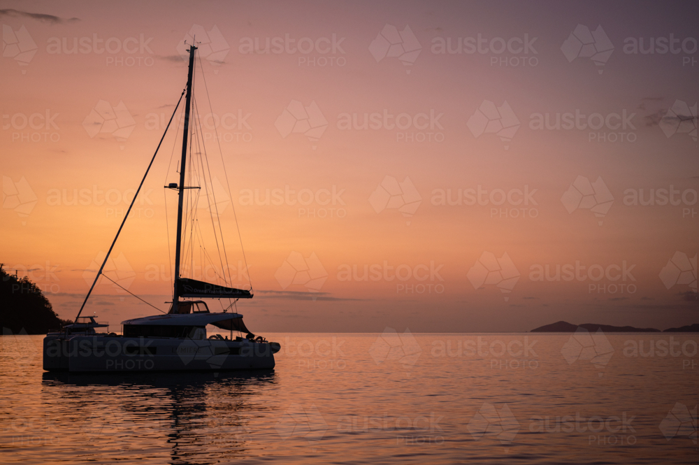 sailing boat in calm water near islands - Australian Stock Image