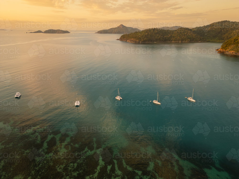 sailing boats in calm water near islands - Australian Stock Image