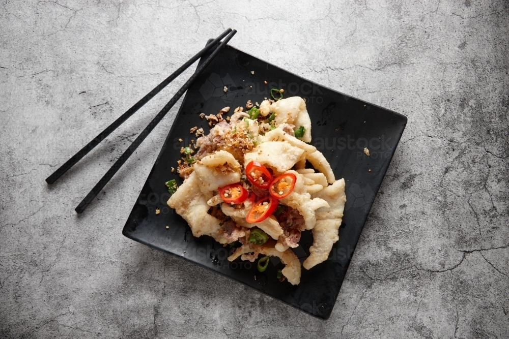 Salt and pepper squid dish on plate - Australian Stock Image