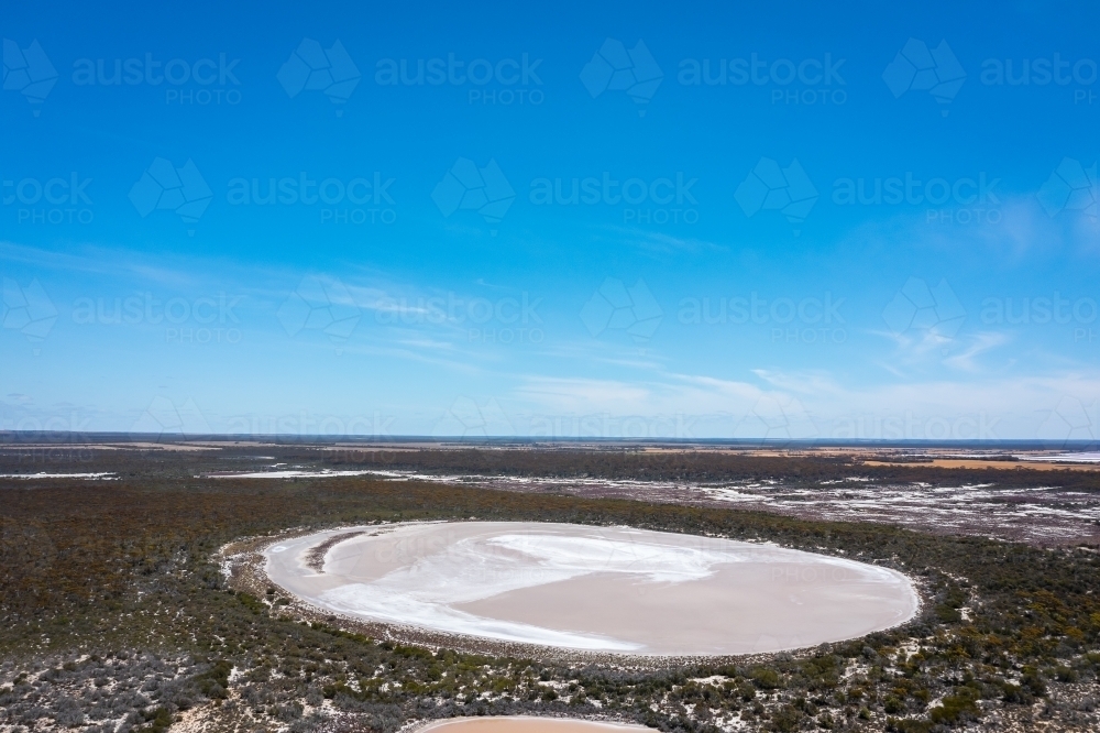 salt lake surrounded by scrub under big blue sky - Australian Stock Image
