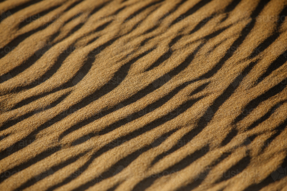 Sand patterns in warm afternoon light - Australian Stock Image