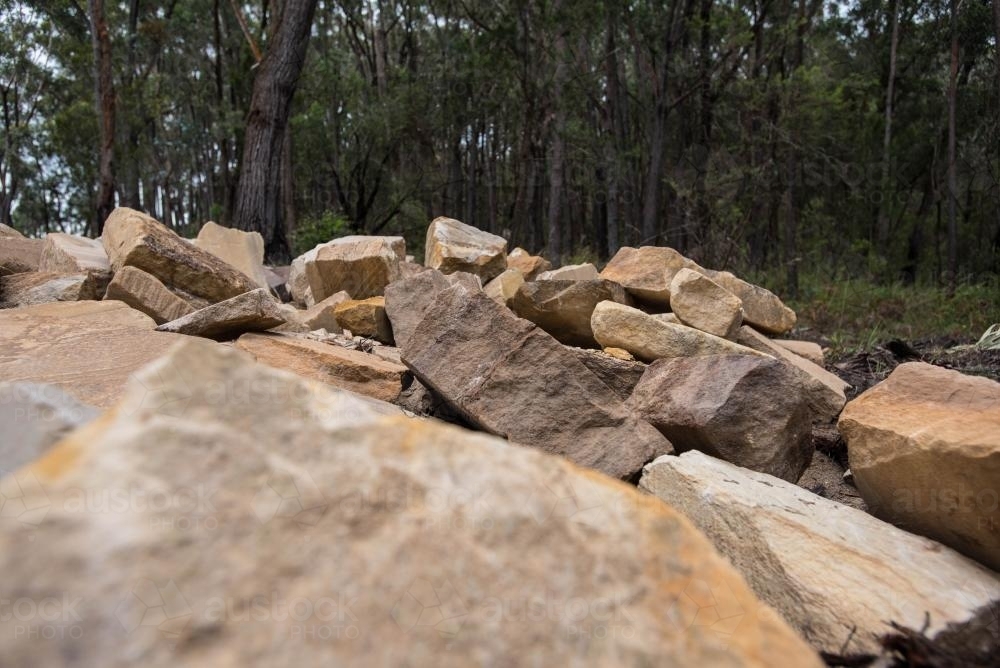Sandstone blocks with trees in background - Australian Stock Image