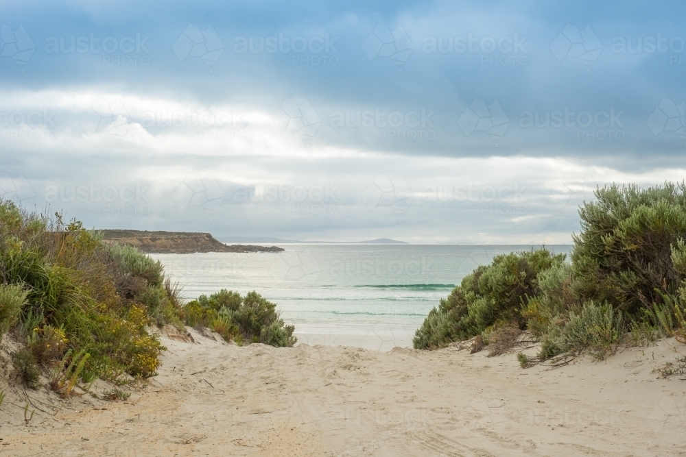 Sandy walkway down to beach on a cloudy day - Australian Stock Image