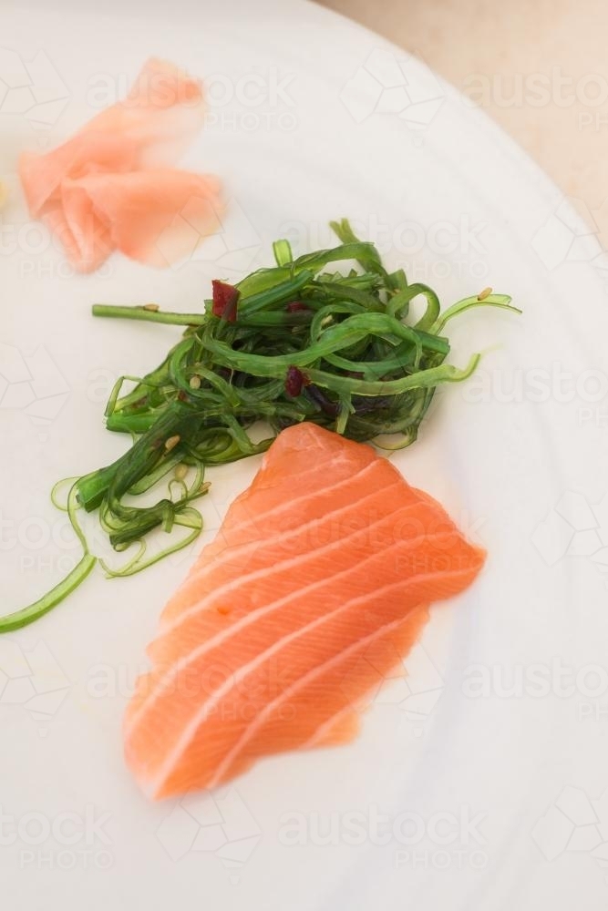 sashimi with Japanese seaweed salad and pickled ginger - Australian Stock Image