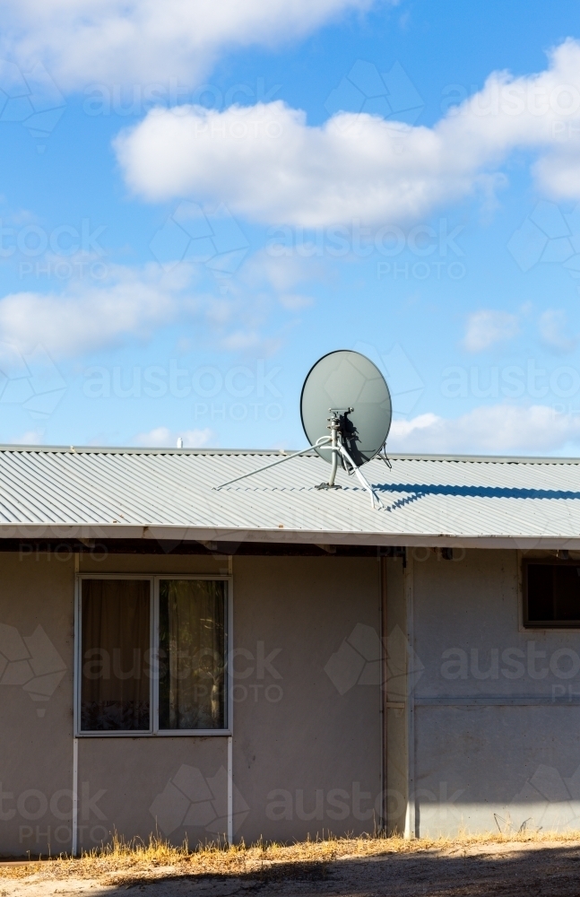 Satellite dish on roof of fibro cottage - Australian Stock Image