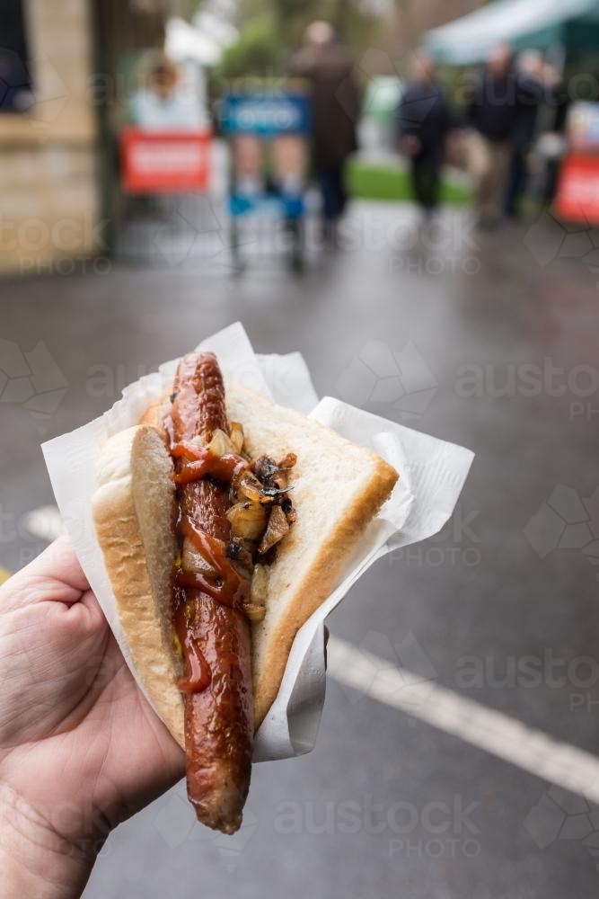Sausage and onion in bread from sausage sizzle at the polling booth - Australian Stock Image