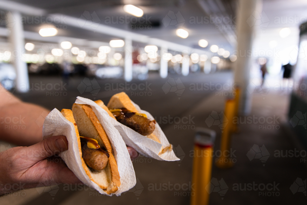 sausage sizzle fundraising sausages with sauce and mustard - Australian Stock Image