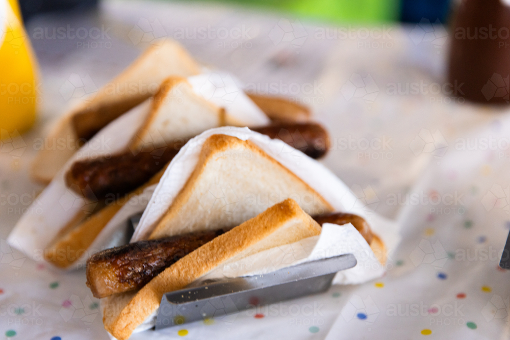 sausage sizzle sausages lined up in a stand - Australian Stock Image