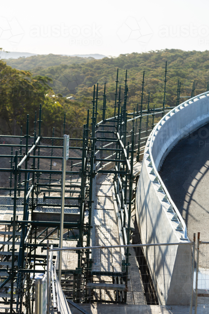 scaffolding and platform beside bridge at worksite - Australian Stock Image