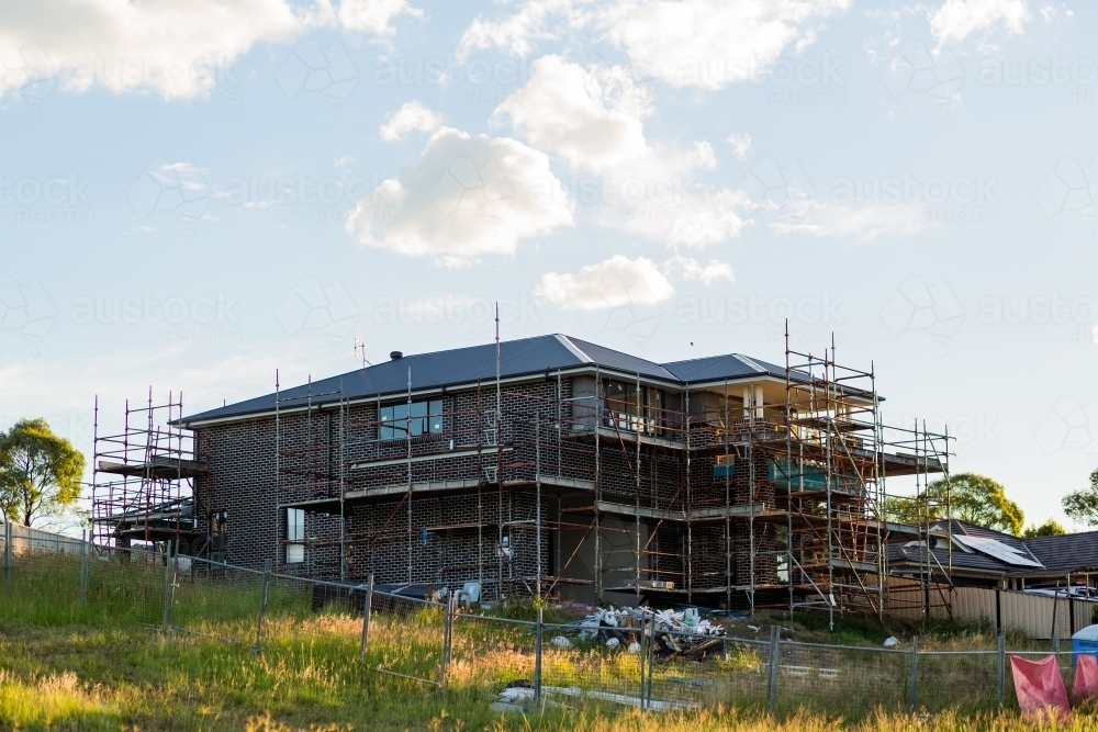 Scaffolding around two storey house under construction - Australian Stock Image