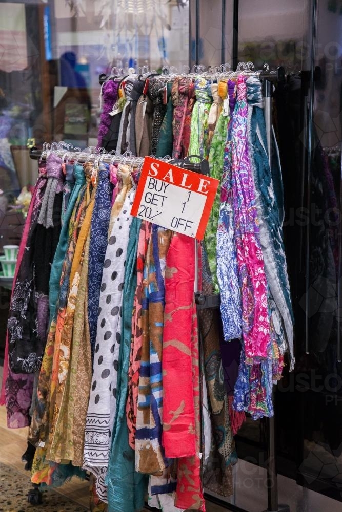 Scarves hanging on a rack outside a shop - Australian Stock Image
