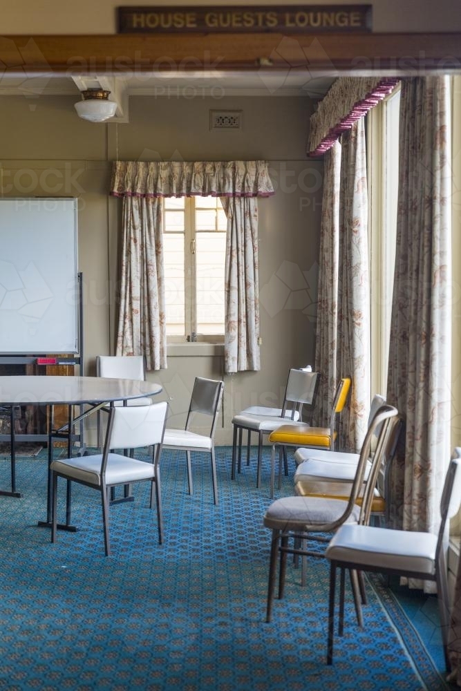 Scattered chairs in empty chalet room - Australian Stock Image