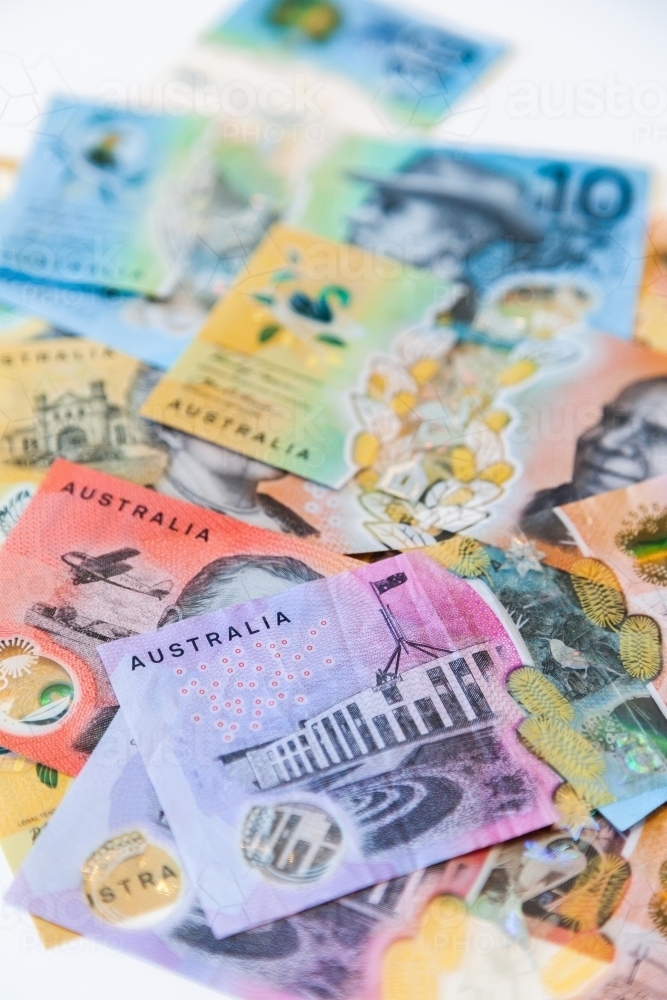 Scattered pile of australian notes in cash five dollars to fifty all new notes - Australian Stock Image