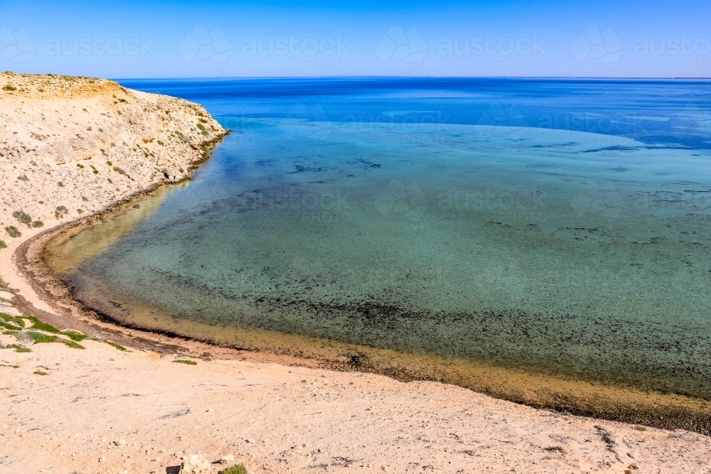 Scenic ocean along arid coastline and blue sky - Australian Stock Image