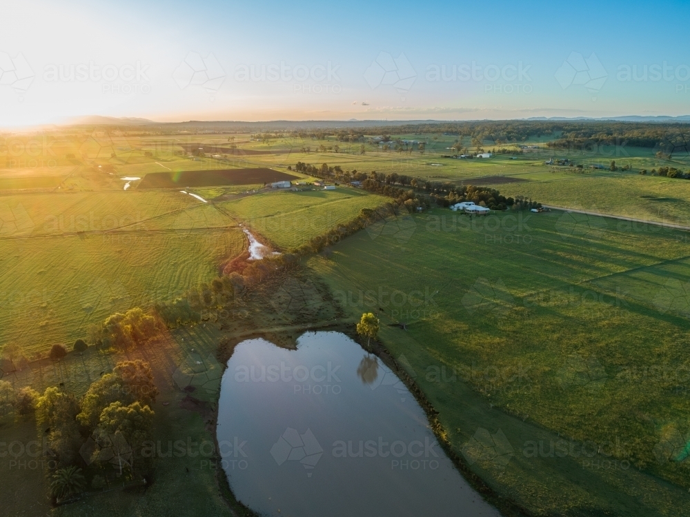 Pretty Paddock Image of Scenic peaceful view of farm paddock with dam at sunset ...