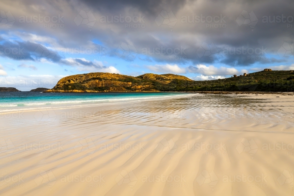 Scenic view of patterns in sand leading to ocean and coastline - Australian Stock Image