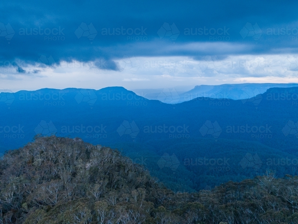 Scenic view of tree covered hills in blue mountains with approaching storm - Australian Stock Image