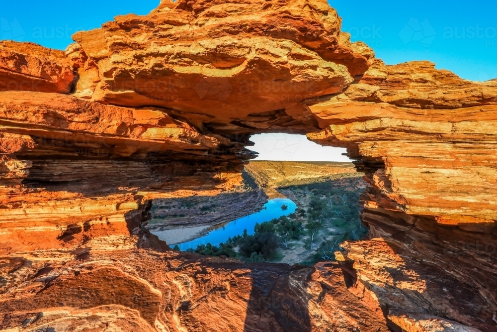 Scenic view through Natures Window natural rock formation to river flowing through gorge - Australian Stock Image