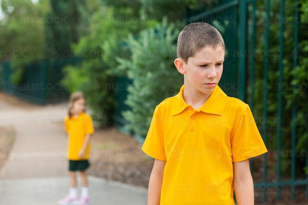 School boy frowning with unsure or sad expression on face - Australian Stock Image