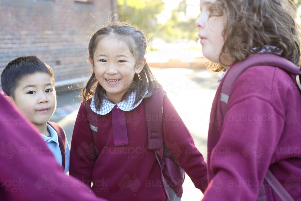 School children holding hands in the playground - Australian Stock Image